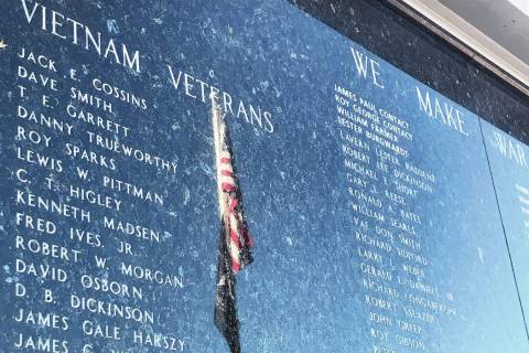 A reflection of the American flag is seen Nov. 7 on a Vietnam veterans panel on Henderson’s V ...