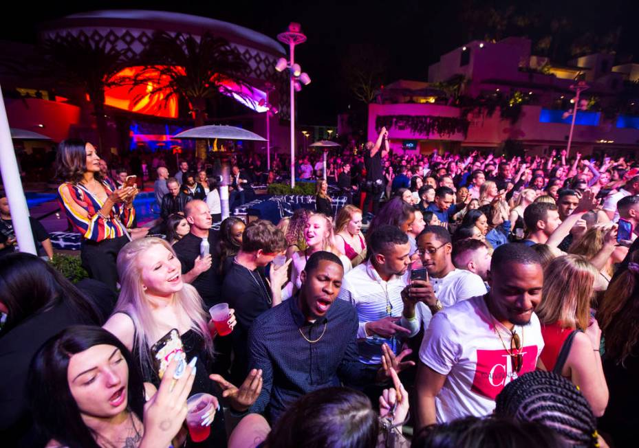 Attendees dance and listen to music as performers entertain by the outdoor stage during the gra ...