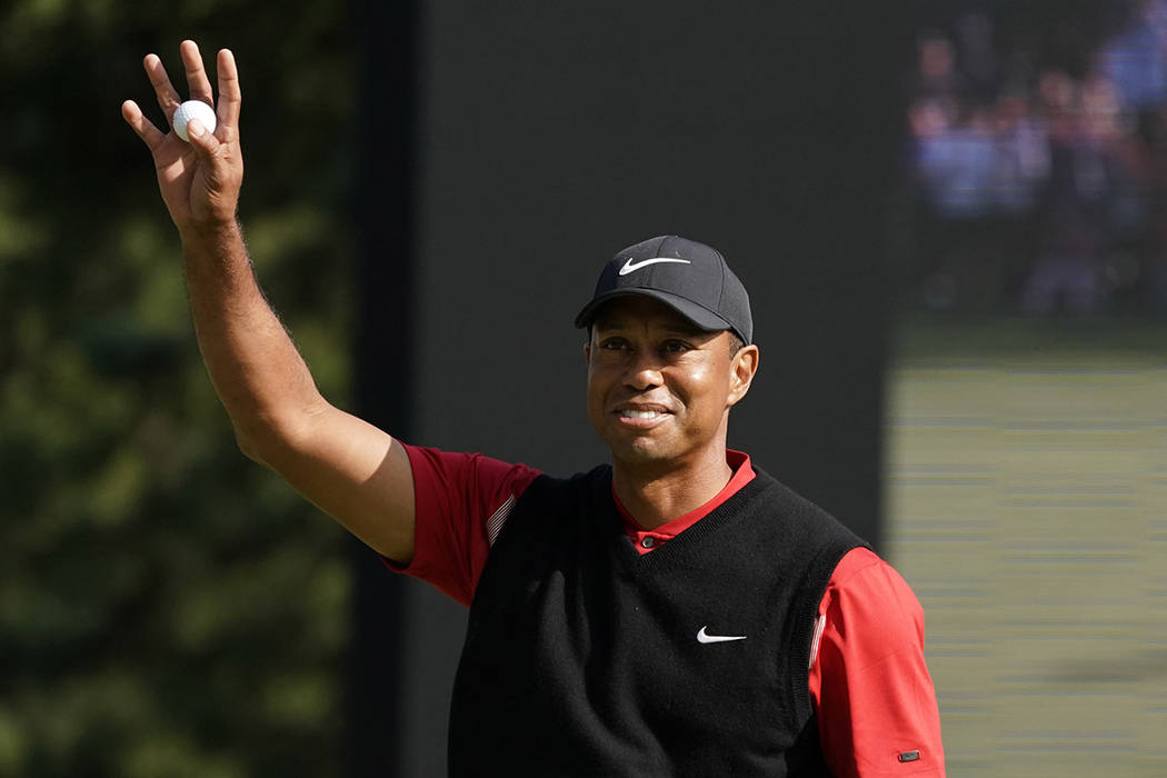 Tiger Woods of the United States reacts after his putt on the 18th hole during the final round ...