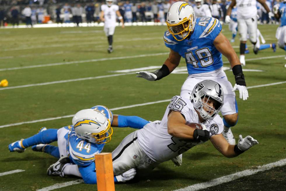 Oakland Raiders running back Alec Ingold (45) dives for the end zone to score past Los Angeles ...