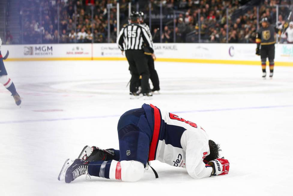 Washington Capitals right wing Tom Wilson reacts after taking a hit from Golden Knights right w ...
