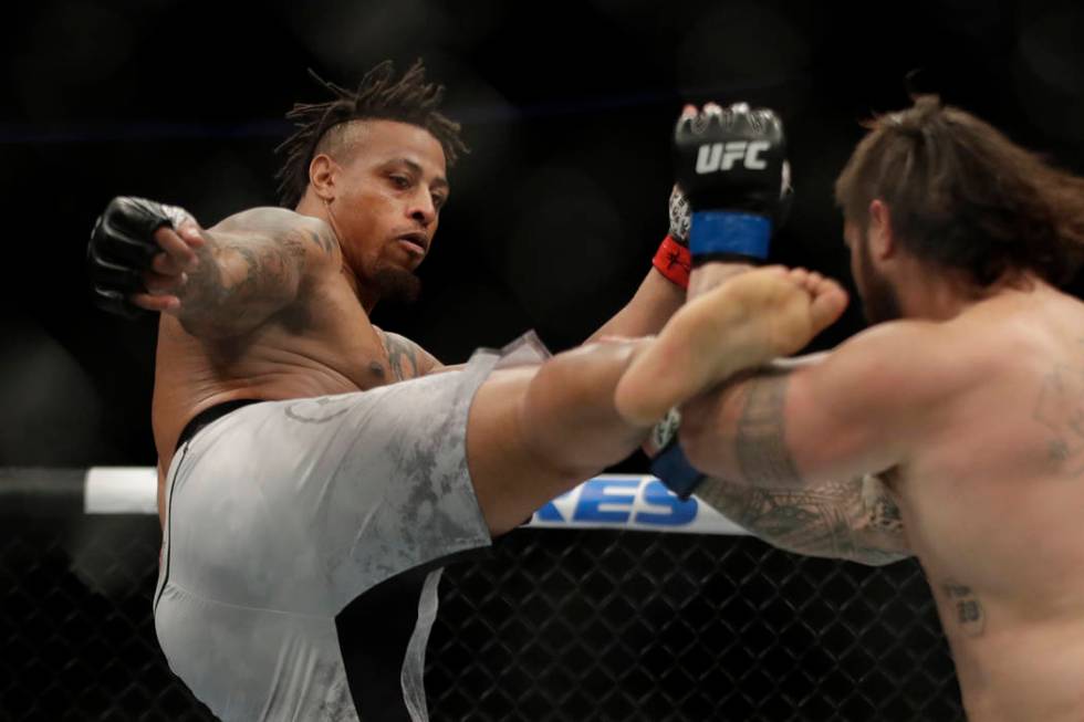 Greg Hardy kicks Ben Sosoli during a heavyweight mixed martial arts bout, Friday, Oct. 18, 2019 ...