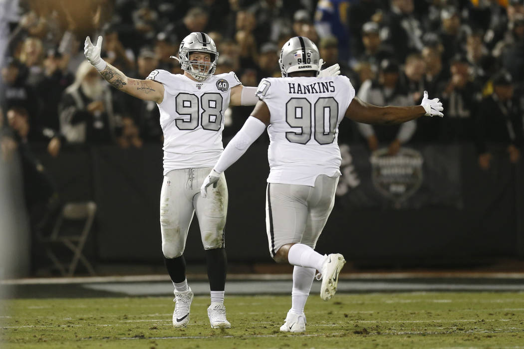 Oakland Raiders defensive end Maxx Crosby (98) celebrates with defensive tackle Johnathan Hanki ...