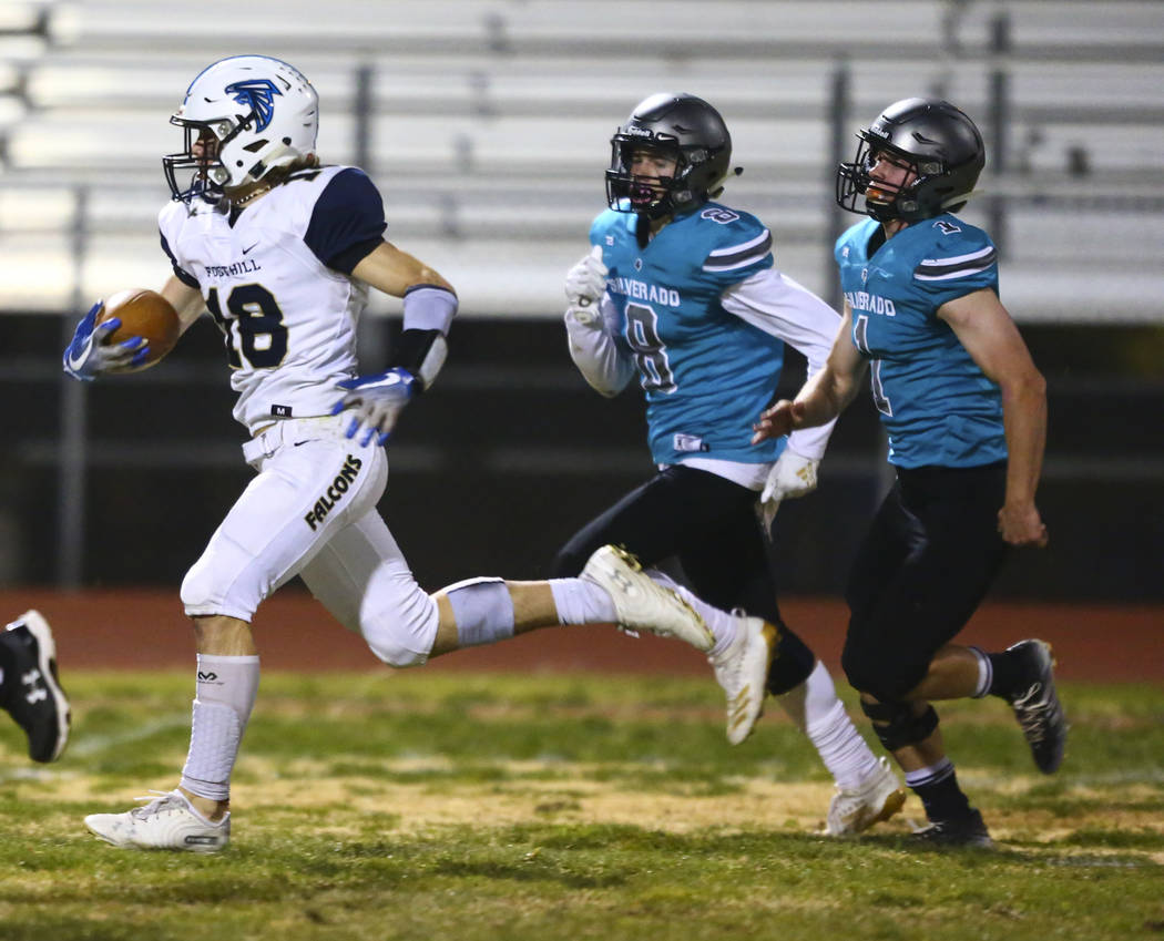 Foothill's Thomas Fisher-welch (18) runs the ball past Silverado's Ryan Kelly (8) and Silverado ...