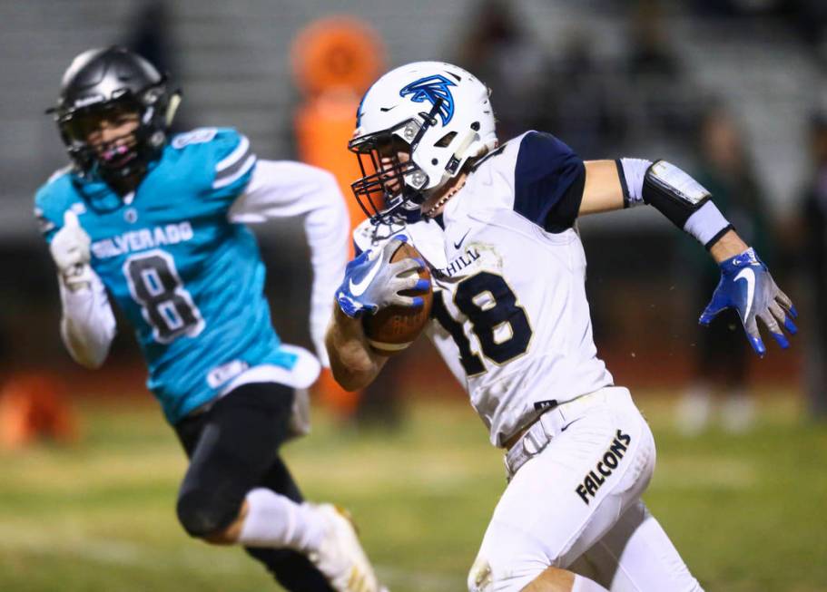 Foothill's Thomas Fisher-Welch (18) runs the ball against Silverado's Ryan Kelly (8) to score a ...