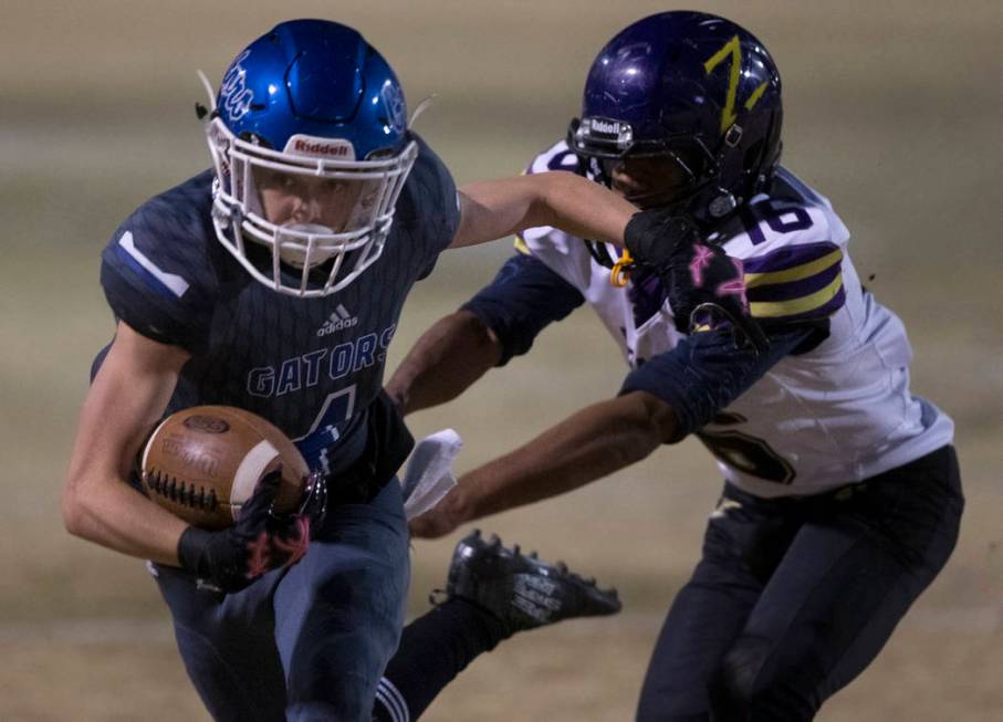 Green Valley's Brady Clayton (4) makes a reception past Durango's Michael Hayword (6) in the se ...