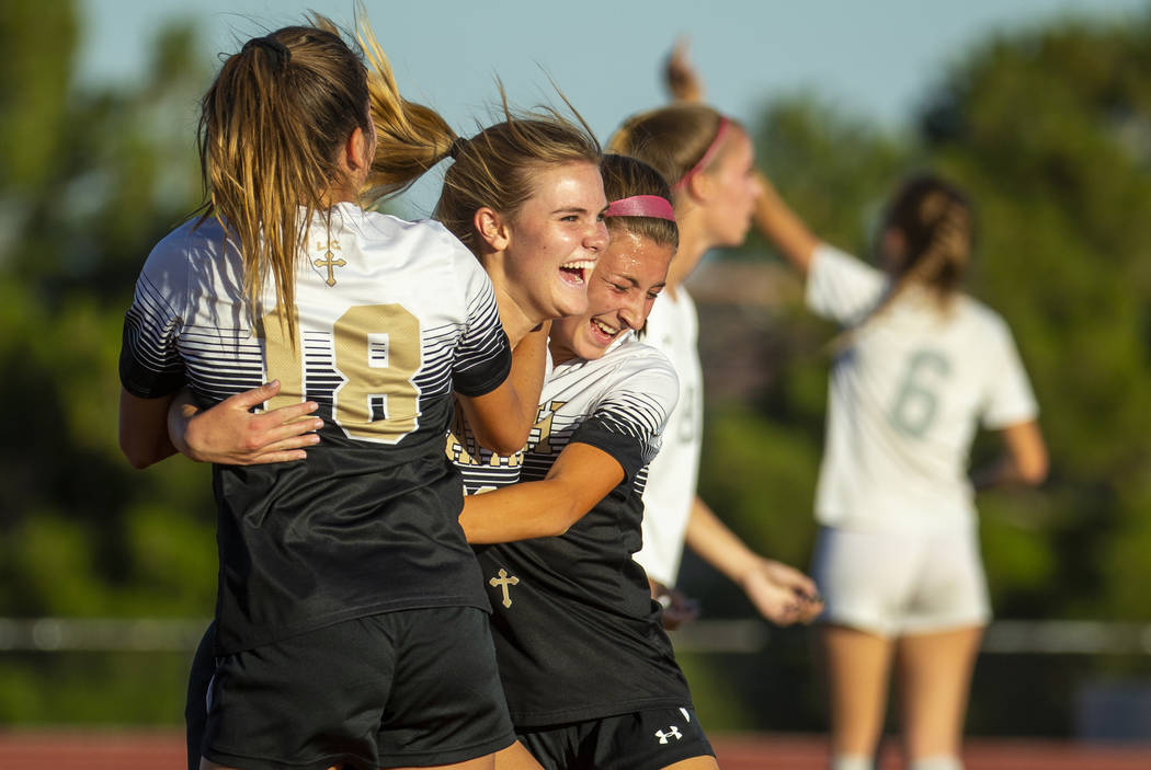 Faith Lutheran's Amelia McManus (20, center) celebrates a goal with teammates Addy Radwanski (1 ...