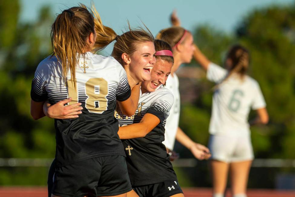 Faith Lutheran's Amelia McManus (20, center) celebrates a goal with teammates Addy Radwanski (1 ...