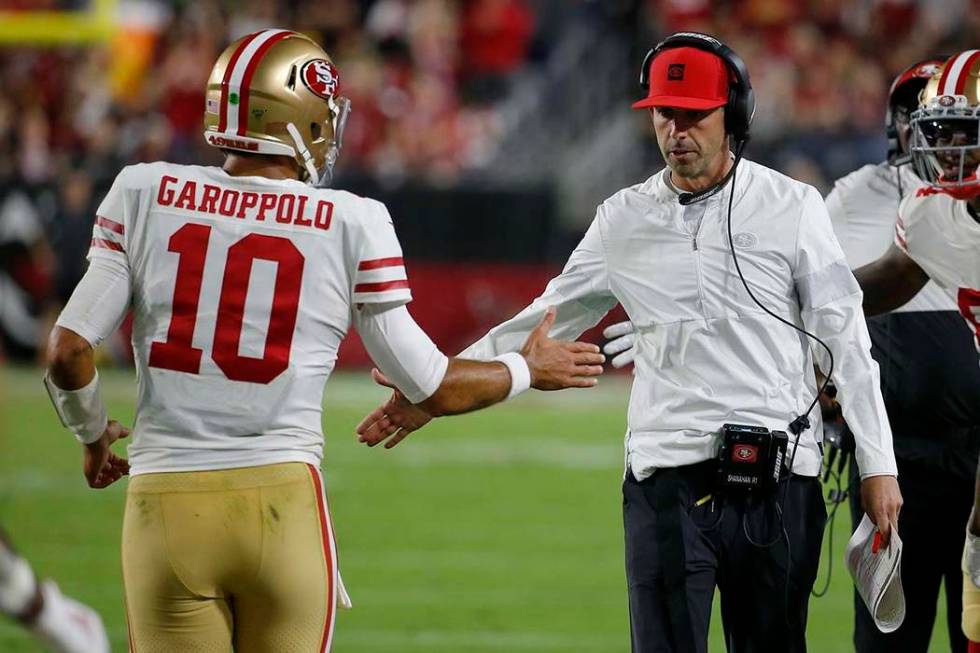 San Francisco 49ers quarterback Jimmy Garoppolo (10) greets San Francisco 49ers head coach Kyle ...