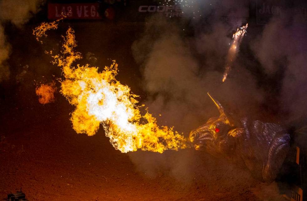 Flames erupt from a metal bull off the stage as cowboys are announced during opening ceremonies ...