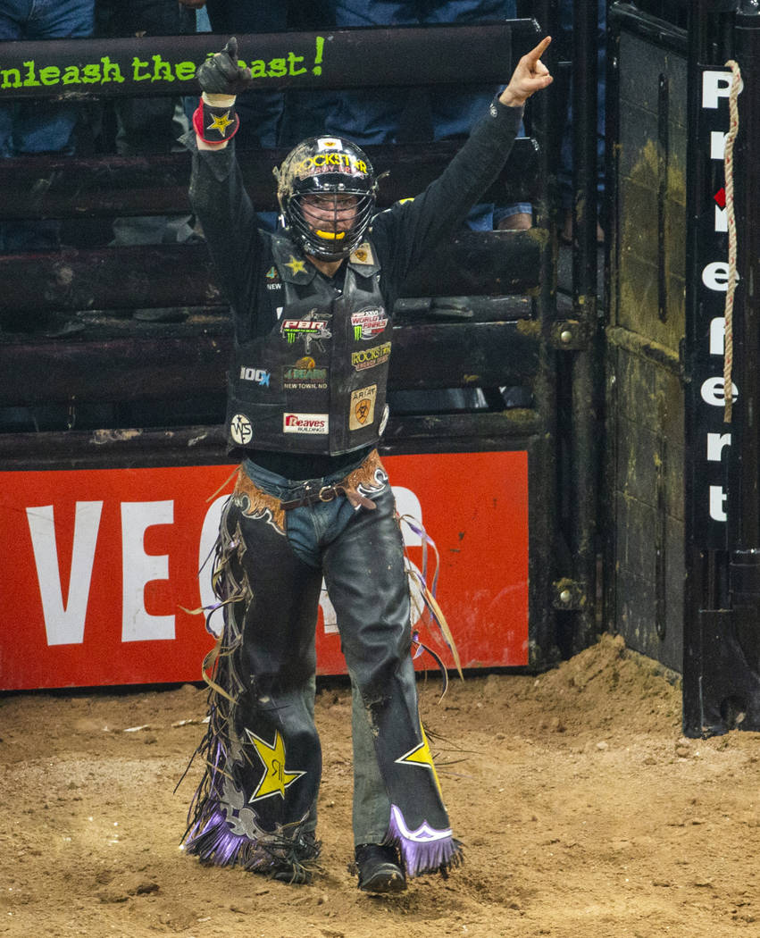 Matt Triplett celebrates his successful ride on Sun Country during the third day of the PBR Wor ...