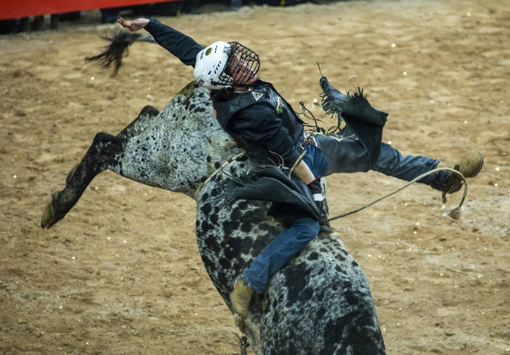 Dylan Smith is bucked on Spotted Snake during the third day of the PBR World Finals at T-Mobile ...