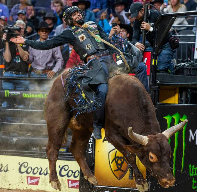 Luciano De Castro sits back atop of Rusty Bones during the fourth day of the PBR World Finals a ...