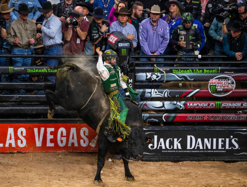 Jess Lockwood rides tall on Rising Sun during the last day of the PBR World Finals at T-Mobile ...