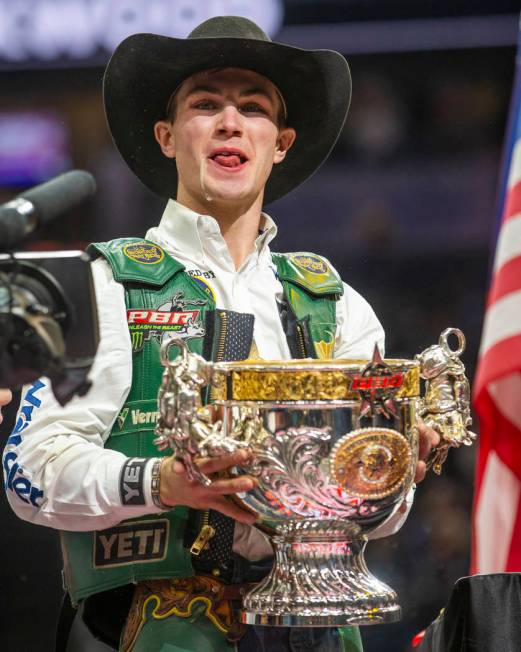 Jess Lockwood laughs after drinking a Coors beer from his winning trophy and being awarded the ...