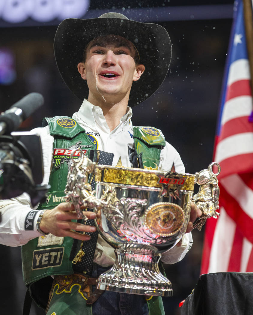 Jess Lockwood laughs after drinking a Coors beer from his winning trophy and being awarded the ...