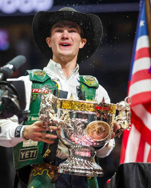 Jess Lockwood laughs after drinking a Coors beer from his winning trophy and being awarded the ...