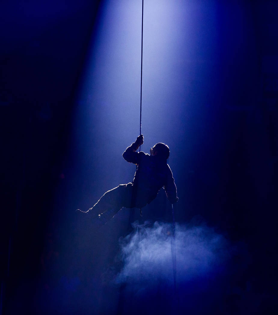 One of four border patrol agents descends from above during opening ceremonies on the last day ...