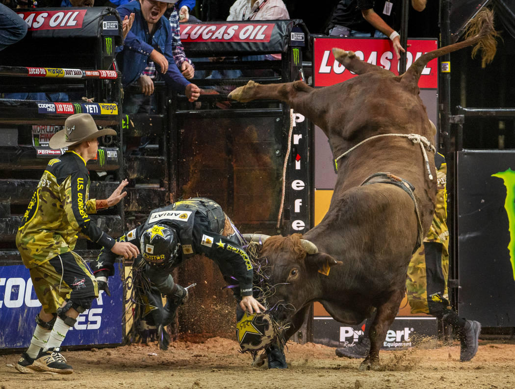 Matt Triplett is sent flying with a shot from Bezerk during the last day of the PBR World Final ...