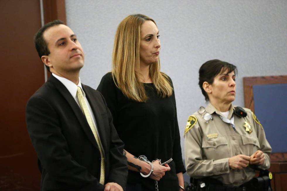 Jailed attorney Alexis Plunkett, center, with her attorney Michael Castillo, left, appears for ...