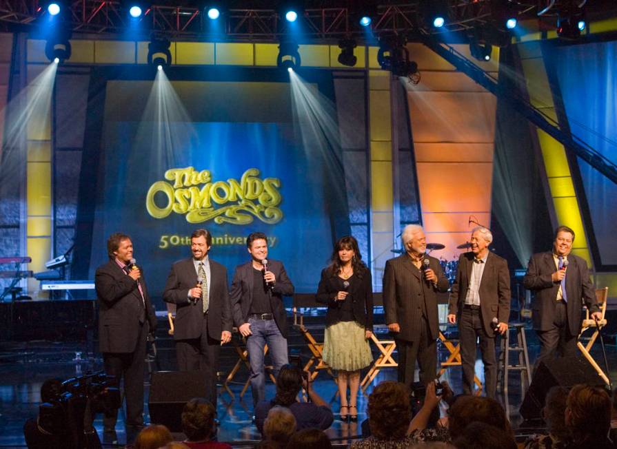 Jimmy, from left, Jay, Donny, Marie, Merrill, Wayne and Alan Osmond stand on stage during a mee ...