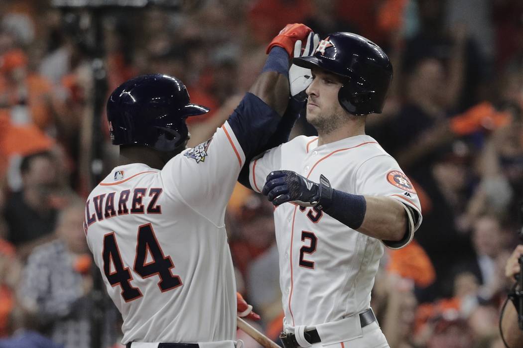 Houston Astros' Alex Bregman is congratulated by Yordan Alvarez after hitting a home run during ...