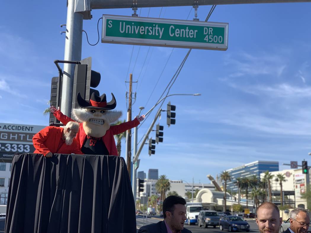 UNLV mascot Hey Reb unveils the first University Center Drive street sign on the southeast corn ...