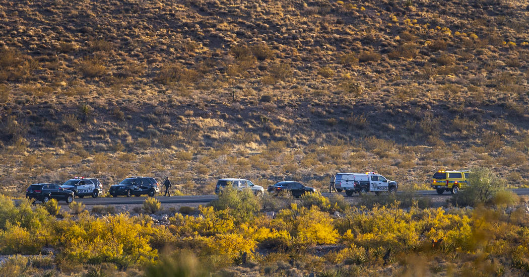 Emergency vehicles line state Route 159 in response to a helicopter crash near Red Rock Canyon ...