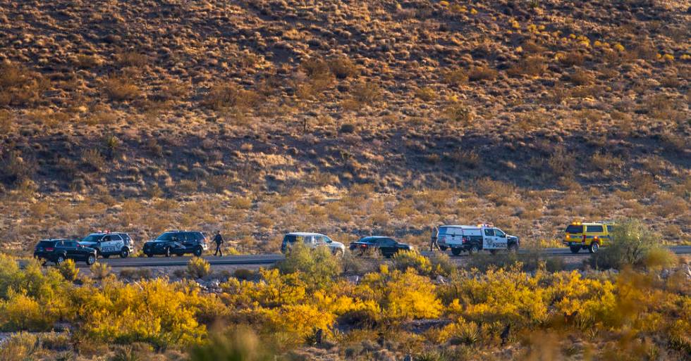 Emergency vehicles line state Route 159 in response to a helicopter crash near Red Rock Canyon ...