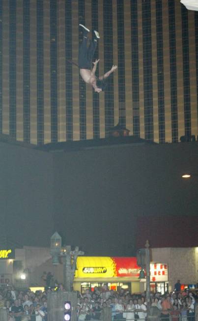 A "Battle of Buccaneer Bay" cast member takes a high dive from the mast of his ship during the ...