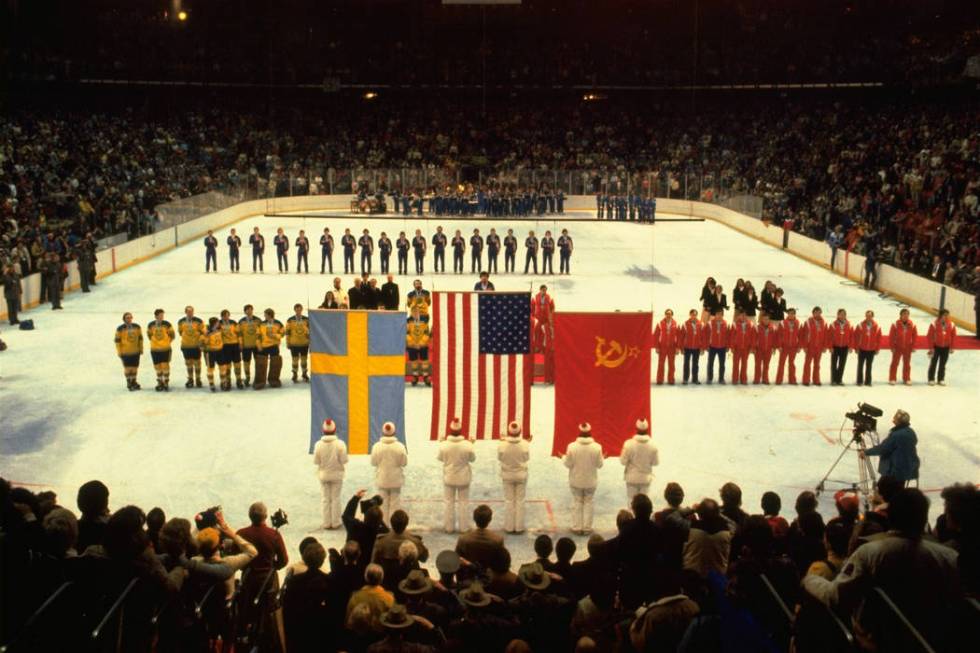 U.S., Swedish, and Soviet teams line up to receive their Olympic gold, bronze, and silver medal ...