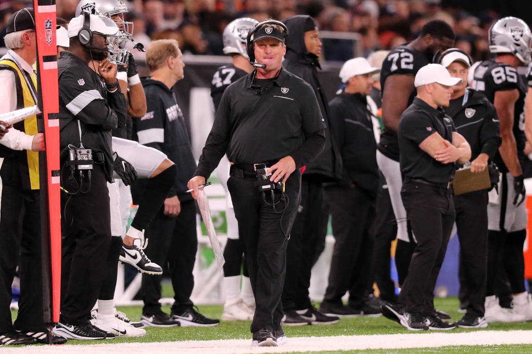 Oakland Raiders head coach Jon Gruden walks the sideline during the first half of an NFL game a ...