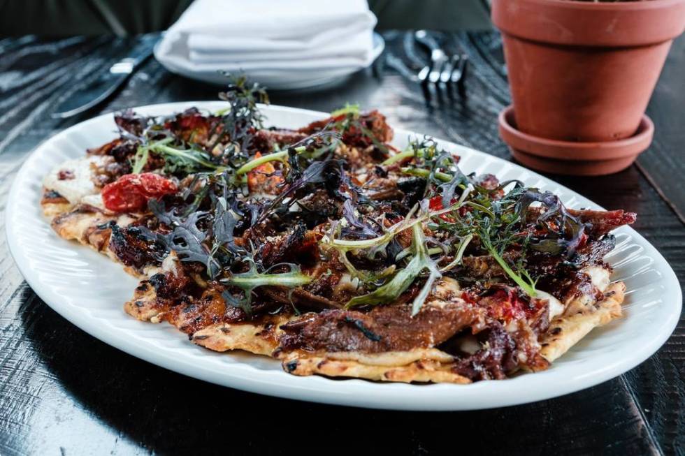 Roasted goat flatbread at The Kitchen at Atomic. (Eugene Dela Cruz)