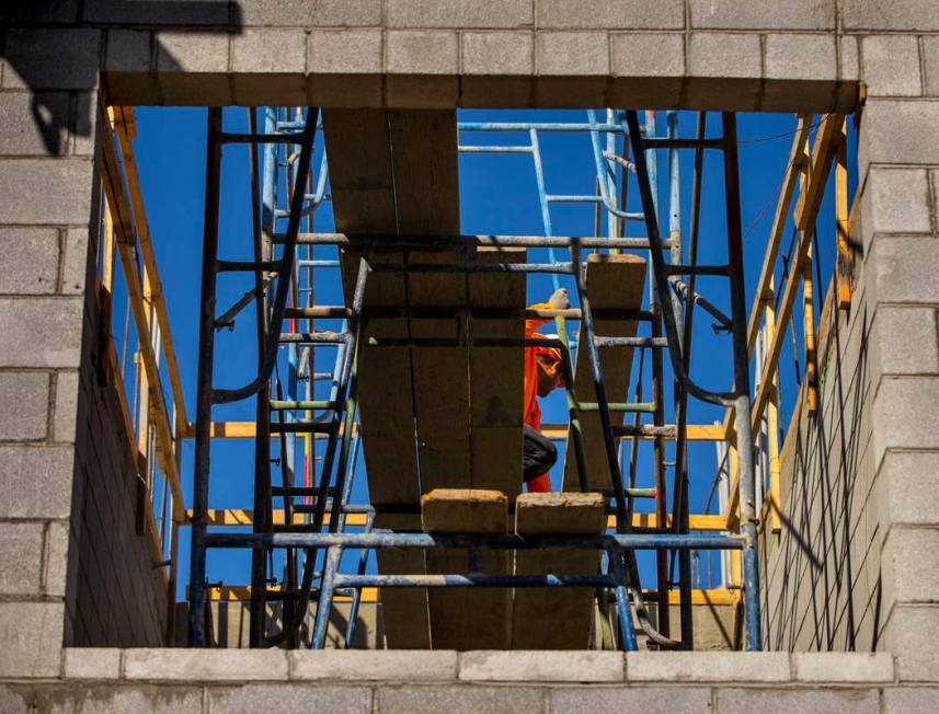 More scaffold is erected on a new apartment complex by developer Jonathan Fore currently under ...