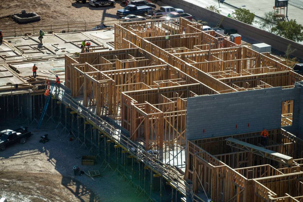 Framers continue on a new apartment complex by developer Jonathan Fore currently under construc ...