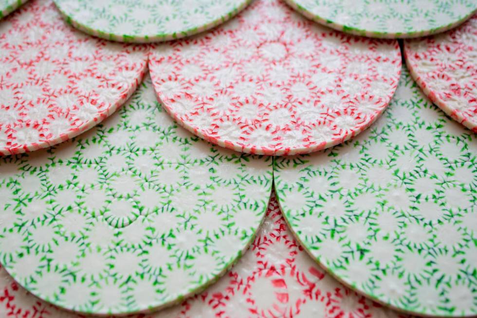 Peppermint disks act as the shingles for a giant gingerbread house in the lobby of the Aria res ...