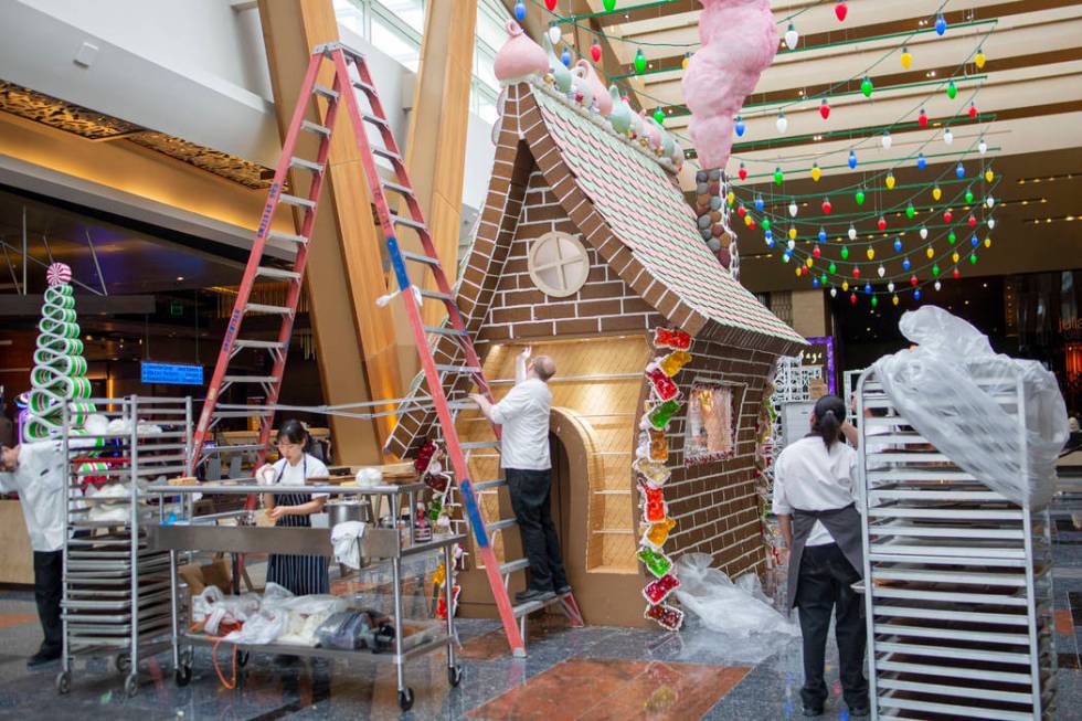 Aria Patisserie pastry chefs work on a giant gingerbread house in the lobby of the Aria resort- ...
