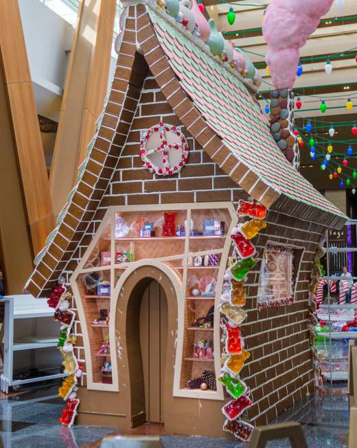 A giant gingerbread house in underway made by Aria Patisserie pastry chefs in the lobby of the ...