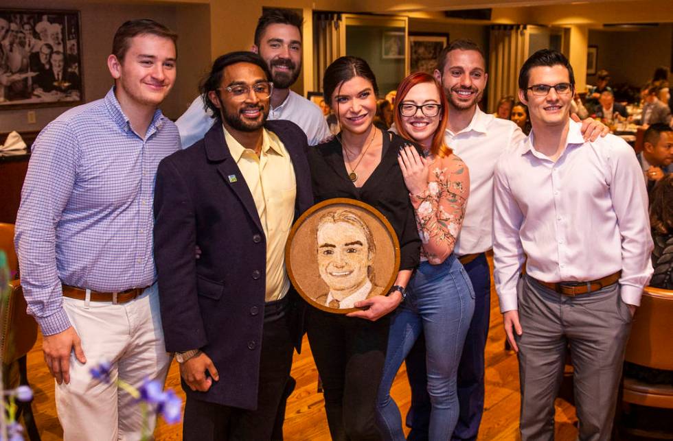 Close friends gather with the completed floragraph of Jacob Jimmerson who is being honored wit ...