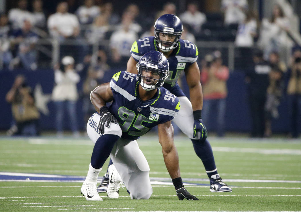 Seattle Seahawks defensive end Dion Jordan (95) and linebacker Bobby Wagner (54) line up agains ...