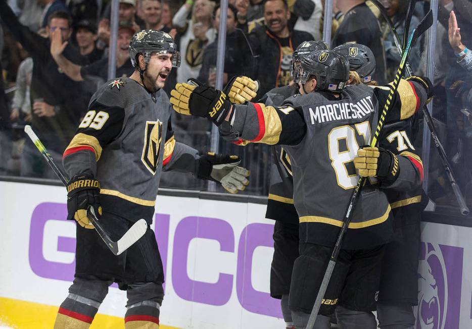 Vegas Golden Knights right wing Alex Tuch (89) celebrates with Vegas Golden Knights center Jona ...