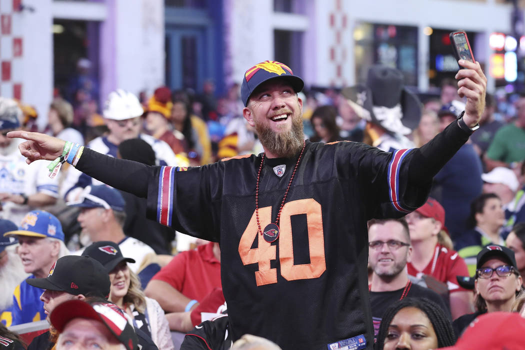 A fan takes a selfie on the main stage during the second round of the NFL football draft, Frida ...