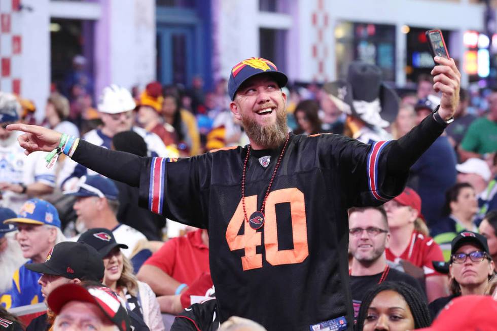 A fan takes a selfie on the main stage during the second round of the NFL football draft, Frida ...