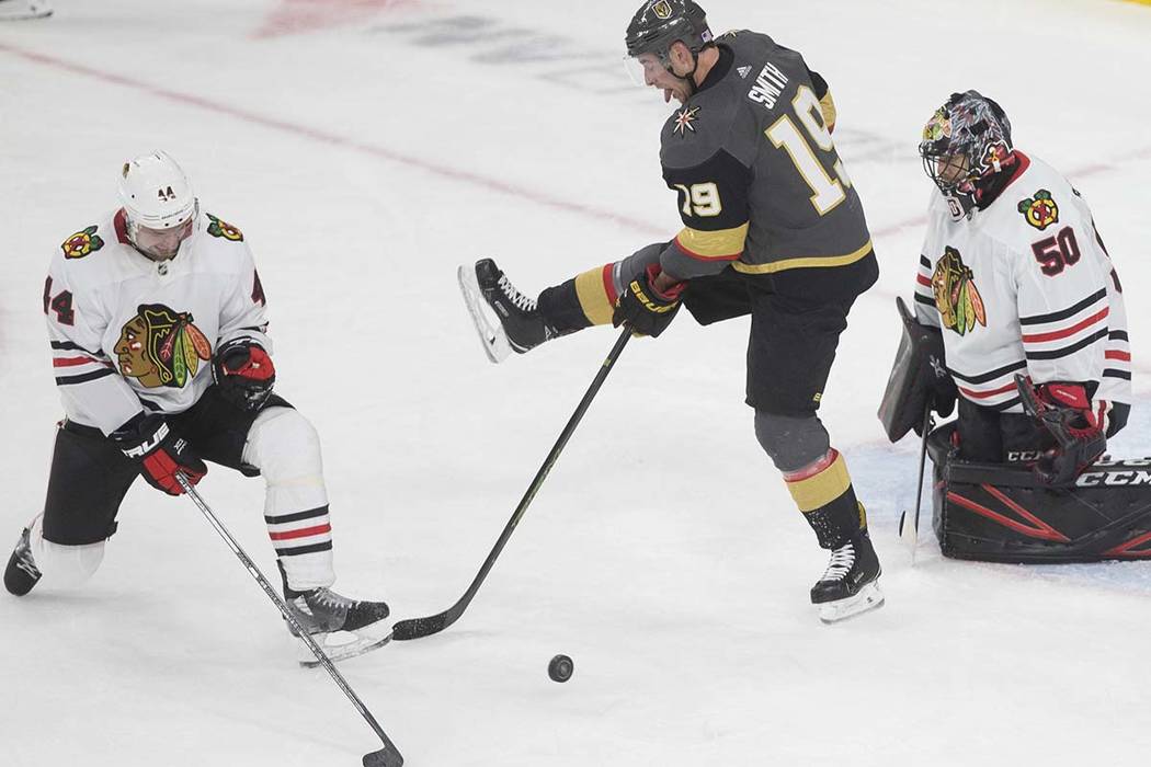 Vegas Golden Knights right wing Reilly Smith (19) tries to deflect a puck past Chicago Blackhaw ...