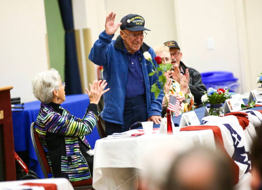 George Pantages, who served in the Navy aboard the USS Princeton, center, is introduced during ...