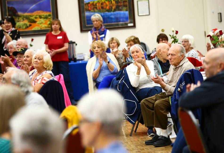 Attendees clap during an event honoring World War II veterans at the Desert Vista Community Cen ...