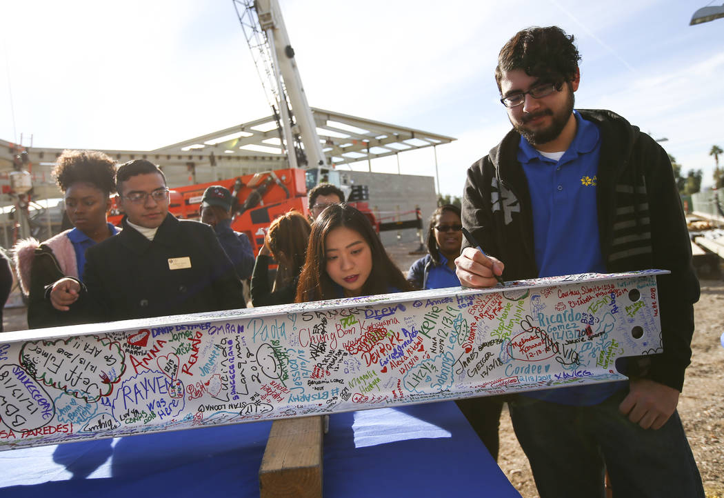 Jeffrey Guadron, right, student government treasurer at College of Southern Nevada, signs a ste ...