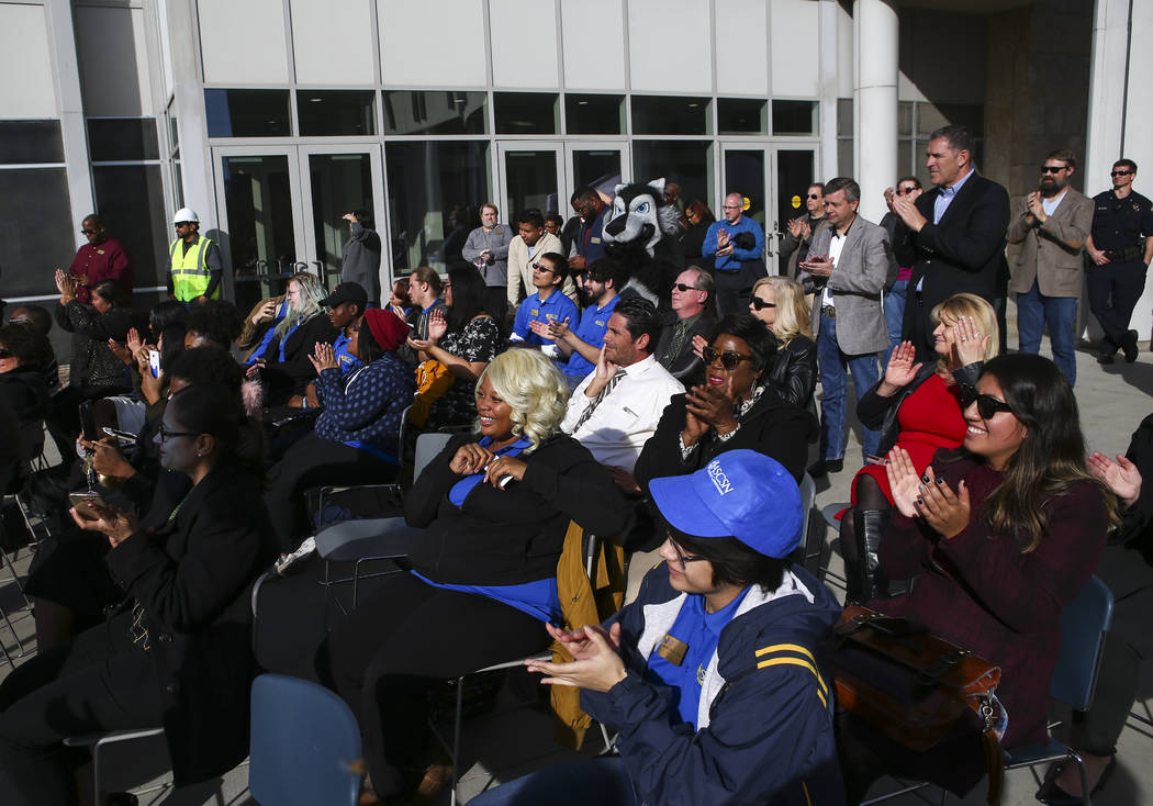 Attendees cheer during a topping off ceremony of the student union building at the College of S ...