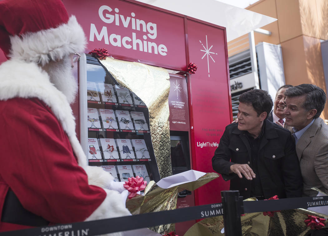 Donny Osmond and Santa Claus unveil the Giving Machine, a vending machine that offers different ...
