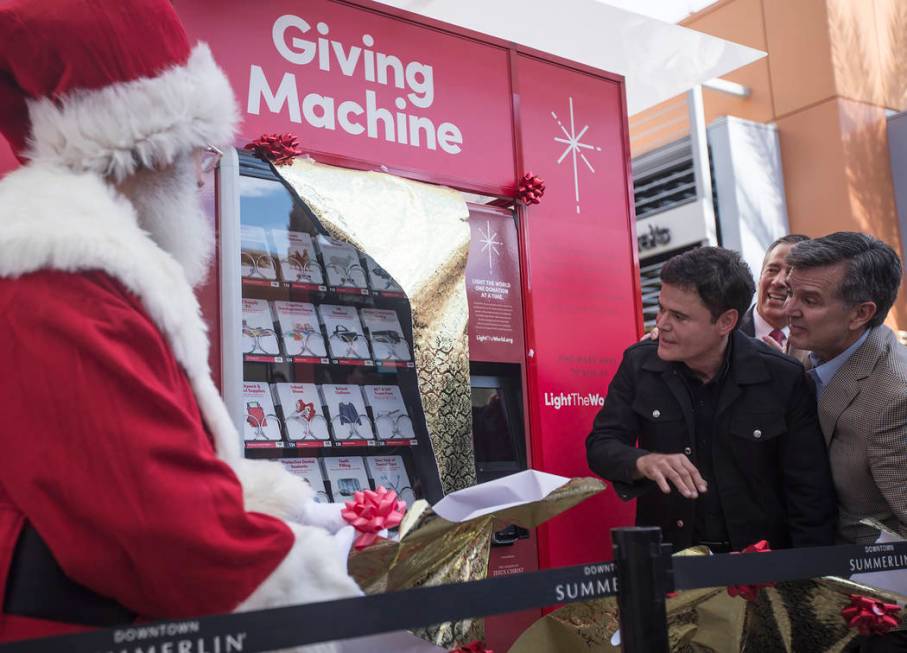 Donny Osmond and Santa Claus unveil the Giving Machine, a vending machine that offers different ...